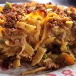 Crostata di tagliolini al forno tagliata a fette con strati di ragù, besciamella e mozzarella filante